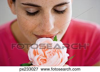 Picture - woman smelling 
flower. fotosearch 
- search stock 
photos, pictures, 
images, and photo 
clipart