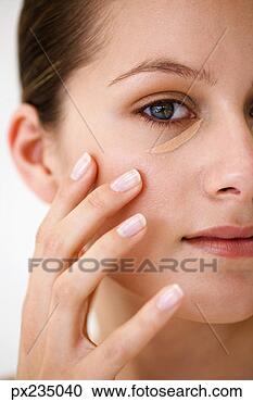 Stock Photography - woman with concealer 
under eye. fotosearch 
- search stock 
photos, pictures, 
images, and photo 
clipart