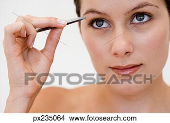 Stock Photo - woman plucking 
eyebrow. fotosearch 
- search stock 
photos, pictures, 
images, and photo 
clipart
