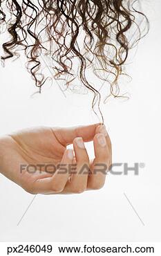 Stock Photograph - woman touching 
her curly hair. 
fotosearch - search 
stock photos, 
pictures, images, 
and photo clipart