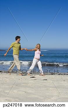 Stock Photo - pregnant couple 
walking on beach. 
fotosearch - search 
stock photos, 
pictures, images, 
and photo clipart