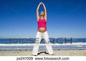 Stock Photograph - pregnant woman 
stretching on 
beach. fotosearch 
- search stock 
photos, pictures, 
images, and photo 
clipart