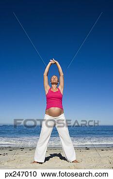 Stock Photography - pregnant woman 
stretching on 
beach. fotosearch 
- search stock 
photos, pictures, 
images, and photo 
clipart