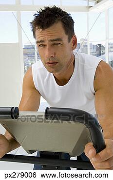Stock Photo - man using exercise 
equipment. fotosearch 
- search stock 
photos, pictures, 
images, and photo 
clipart