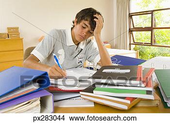 Stock Photo - frustrated teenage 
boy doing homework. 
fotosearch - search 
stock photos, 
pictures, images, 
and photo clipart