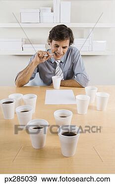 Stock Photograph - businessman working 
with cups of coffee. 
fotosearch - search 
stock photos, 
pictures, images, 
and photo clipart