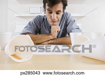 Stock Photo - businessman working 
with cups of coffee. 
fotosearch - search 
stock photos, 
pictures, images, 
and photo clipart