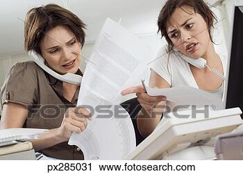 Stock Photography - businesswomen 
talking on phones 
in office. fotosearch 
- search stock 
photos, pictures, 
images, and photo 
clipart