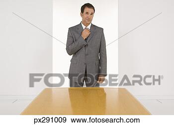 Stock Photograph - businessman adjusting 
tie. fotosearch 
- search stock 
photos, pictures, 
images, and photo 
clipart