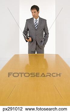Stock Photo - businessman holding 
organizer. fotosearch 
- search stock 
photos, pictures, 
images, and photo 
clipart