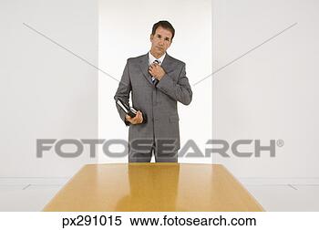 Stock Image - businessman holding 
organizer. fotosearch 
- search stock 
photos, pictures, 
images, and photo 
clipart