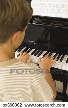 Stock Photo - boy playing piano. 
fotosearch - search 
stock photos, 
pictures, images, 
and photo clipart