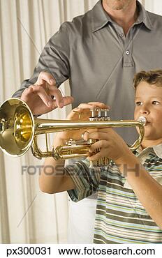 Stock Photography - boy playing trumpet 
with instructor. 
fotosearch - search 
stock photos, 
pictures, images, 
and photo clipart