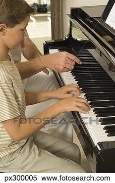 Stock Image - instructor and 
boy playing piano. 
fotosearch - search 
stock photos, 
pictures, images, 
and photo clipart
