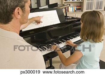 Stock Photograph - man and girl playing 
piano. fotosearch 
- search stock 
photos, pictures, 
images, and photo 
clipart