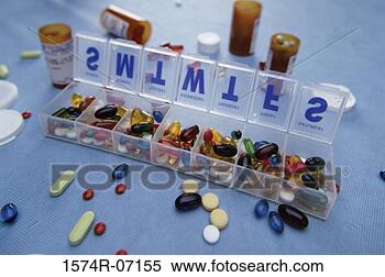 Stock Image - assortment of 
tablets and capsules 
in a pill box 
and vials. fotosearch 
- search stock 
photos, pictures, 
images, and photo 
clipart