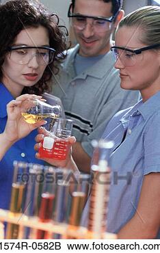 Stock Photo - two young women 
and a young man 
pouring liquid 
from a flask into 
a. fotosearch 
- search stock 
photos, pictures, 
images, and photo 
clipart