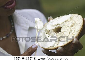 Stock Photo - close-up of a 
young woman holding 
a bagel. fotosearch 
- search stock 
photos, pictures, 
images, and photo 
clipart