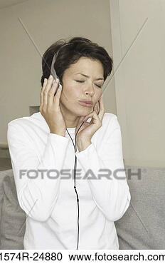 Stock Photography - close-up of a 
young woman wearing 
headphones and 
listening to music. 
fotosearch - search 
stock photos, 
pictures, images, 
and photo clipart