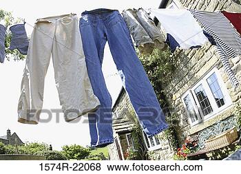 Stock Photo - low angle view 
of clothes drying 
on a clothes line. 
fotosearch - search 
stock photos, 
pictures, images, 
and photo clipart