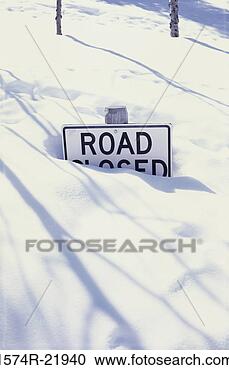 Stock Photography - a road closed 
sign buried in 
snow. fotosearch 
- search stock 
photos, pictures, 
images, and photo 
clipart