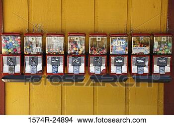 Stock Photo - row of gumball 
machines attached 
to a wall. fotosearch 
- search stock 
photos, pictures, 
images, and photo 
clipart