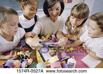 Stock Photo - female teacher 
teaching her students 
arts and crafts. 
fotosearch - search 
stock photos, 
pictures, images, 
and photo clipart