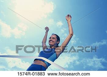 Stock Photo - low angle view 
of a female athlete 
crossing the finishing 
line. fotosearch 
- search stock 
photos, pictures, 
images, and photo 
clipart