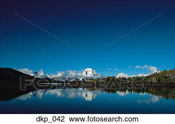 Stock Photo - snow covered mountain 
range and the 
reflection in 
a lake. fotosearch 
- search stock 
photos, pictures, 
images, and photo 
clipart
