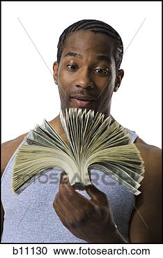 Stock Photography - african american 
holding a pile 
of dollar bills. 
fotosearch - search 
stock photos, 
pictures, images, 
and photo clipart