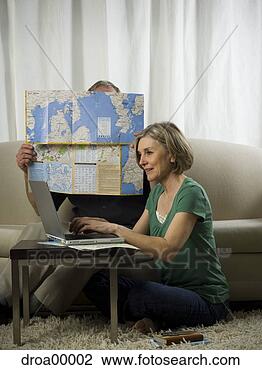 Stock Photo - elderly woman 
sitting in front 
of a laptop with 
an elderly man. 
fotosearch - search 
stock photos, 
pictures, images, 
and photo clipart