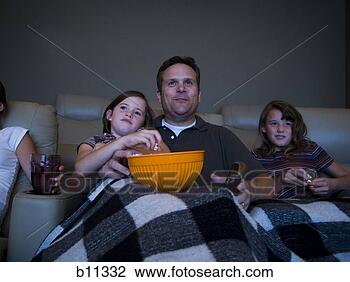 Stock Photo - father and daughters 
watching movie 
in home theater. 
fotosearch - search 
stock photos, 
pictures, images, 
and photo clipart