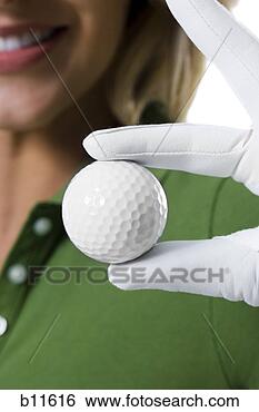 Stock Photo - female golfer 
and close-up of 
golf ball. fotosearch 
- search stock 
photos, pictures, 
images, and photo 
clipart