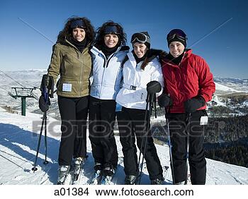 Stock Photo - four women standing 
outdoors in winter 
with skis. fotosearch 
- search stock 
photos, pictures, 
images, and photo 
clipart