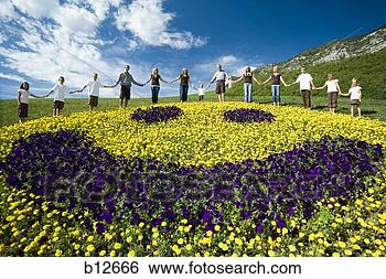 Stock Photo - large family group 
on hill with happy 
face floral display. 
fotosearch - search 
stock photos, 
pictures, images, 
and photo clipart