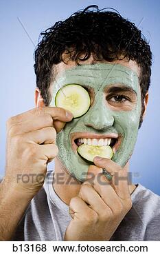 Stock Photo - man with facial 
mask and cucumber 
slices. fotosearch 
- search stock 
photos, pictures, 
images, and photo 
clipart