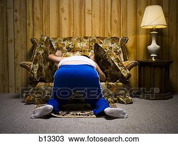 Stock Photo - man looking under 
sofa cushion. 
fotosearch - search 
stock photos, 
pictures, images, 
and photo clipart