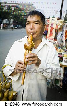 Stock Photo - man playing a 
chinese woodwind 
instrument. fotosearch 
- search stock 
photos, pictures, 
images, and photo 
clipart