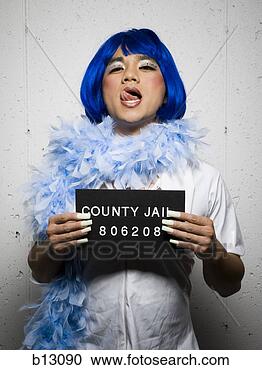 Stock Photography - mug shot of man  in drag with blue  wig and feather  boa. fotosearch  - search stock  photos, pictures,  wall murals, images,  and photo clipart
