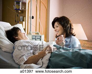 Picture - older woman in 
hospital holding 
hands with woman 
smiling. fotosearch 
- search stock 
photos, pictures, 
images, and photo 
clipart