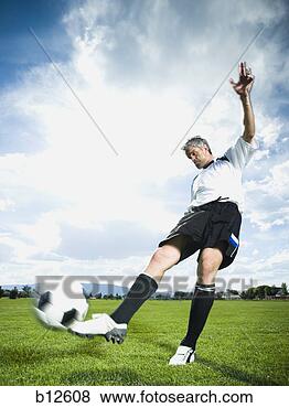 Stock Photo - soccer player 
kicking ball. 
fotosearch - search 
stock photos, 
pictures, images, 
and photo clipart