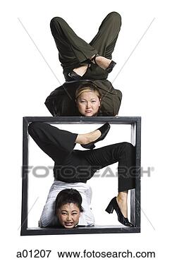 Picture - two female contortionist 
businesswomen. 
fotosearch - search 
stock photos, 
pictures, images, 
and photo clipart