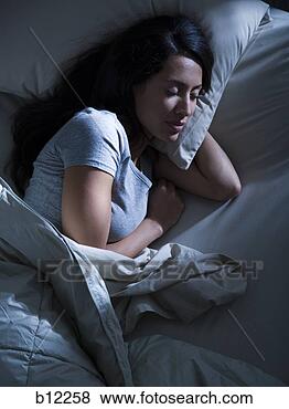 Stock Photo - woman in bed in 
the dark. fotosearch 
- search stock 
photos, pictures, 
images, and photo 
clipart