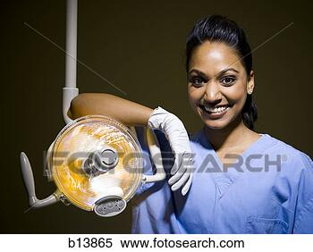 Stock Image - woman in nurses 
uniform leaning 
on medical light. 
fotosearch - search 
stock photos, 
pictures, images, 
and photo clipart