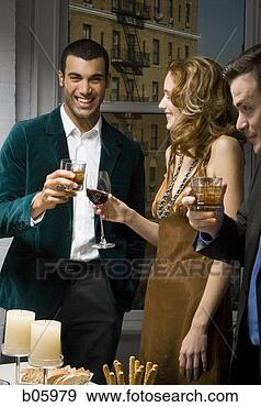 Stock Photograph - partygoers toasting. 
fotosearch - search 
stock photos, 
pictures, images, 
and photo clipart