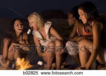 Stock Image - four young women 
sitting at a campfire. 
fotosearch - search 
stock photos, 
pictures, images, 
and photo clipart