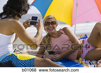 Stock Photo - rear view of a 
young man taking 
a young woman's 
photograph. fotosearch 
- search stock 
photos, pictures, 
images, and photo 
clipart