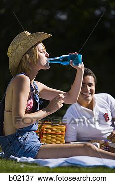 Picture - young woman drinking 
beer in a park. 
fotosearch - search 
stock photos, 
pictures, images, 
and photo clipart