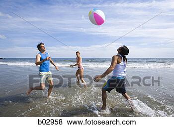 Stock Photo - three young people 
at the beach. 
fotosearch - search 
stock photos, 
pictures, images, 
and photo clipart