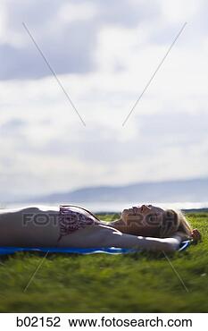 Stock Photo - young woman lying 
down on a field. 
fotosearch - search 
stock photos, 
pictures, images, 
and photo clipart